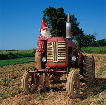 red dwarf - Gnome leaning on a tractor Stock Photo - Premium Royalty-Free, Code: 614-00656874