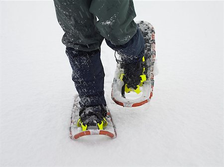 Person wearing snow shoes Stock Photo - Premium Royalty-Free, Code: 614-00658593