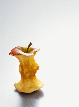 Apple core on a table Stock Photo - Premium Royalty-Free, Code: 614-00659164