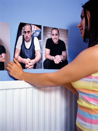 female on a radiator - Girl attaching posters to wall Stock Photo - Premium Royalty-Free, Code: 614-00653458