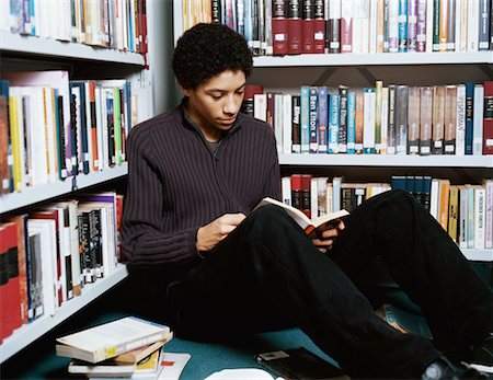 simsearch:614-00657328,k - Teenage boy reading in library Stock Photo - Premium Royalty-Free, Code: 614-00809351