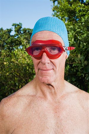 Senior adult man wearing swimming goggles Stock Photo - Premium Royalty-Free, Code: 614-00892274