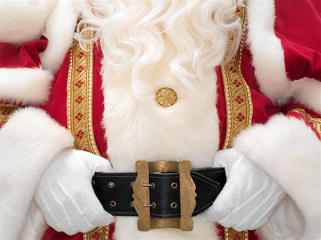 simsearch:693-06435898,k - Santa holding onto belt Stock Photo - Premium Royalty-Free, Code: 614-00913726