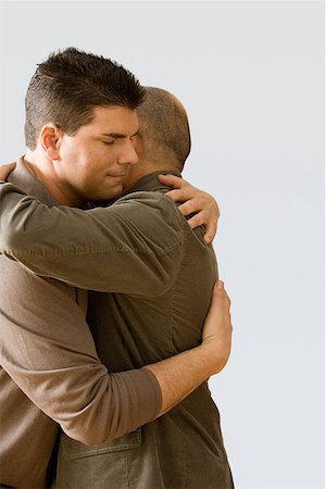 Father and son hugging Stock Photo - Premium Royalty-Free, Code: 614-00913935