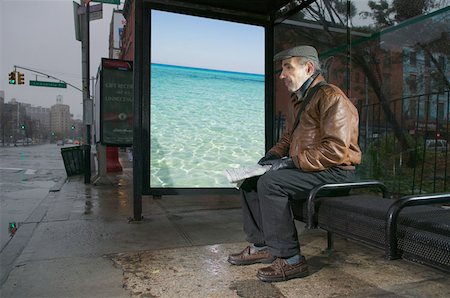 summer winter sign - Man daydreaming in bus shelter Stock Photo - Premium Royalty-Free, Code: 614-00966440