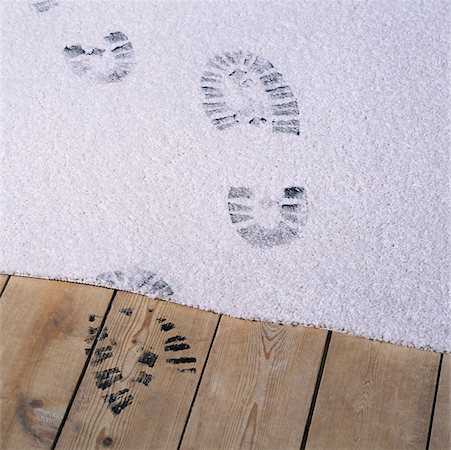 Black footprints on a carpet Stock Photo - Premium Royalty-Free, Code: 614-01026363