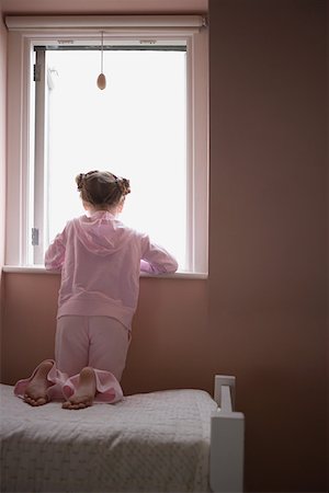 Girl looking out of window Stock Photo - Premium Royalty-Free, Code: 614-01028981