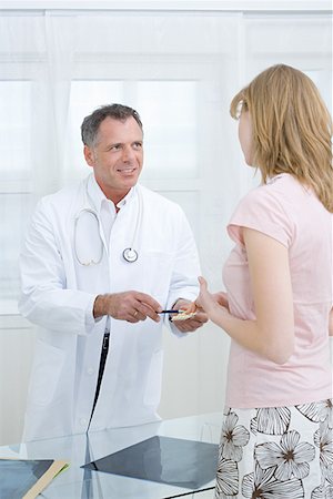 doctor consulting patient tablet - Doctor giving tablets to patient Stock Photo - Premium Royalty-Free, Code: 614-01086418