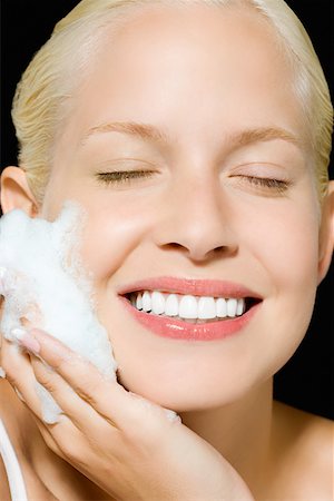 Woman washing her face Stock Photo - Premium Royalty-Free, Code: 614-01088582