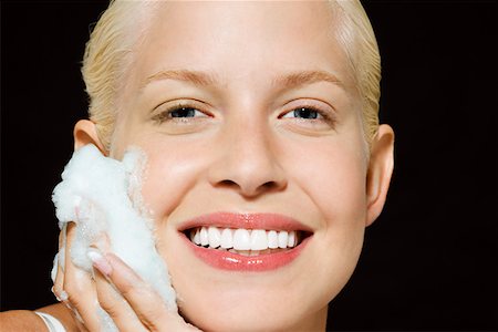 Woman washing her face Stock Photo - Premium Royalty-Free, Code: 614-01088590