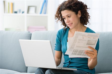 Woman paying bills online Stock Photo - Premium Royalty-Free, Code: 614-01178544
