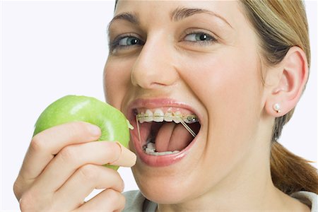 Woman eating apple Stock Photo - Premium Royalty-Free, Code: 614-01179919