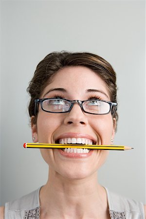 Woman with pencil in her mouth Stock Photo - Premium Royalty-Free, Code: 614-01237326