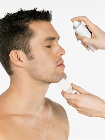 Man having water sprayed on his face Stock Photo - Premium Royalty-Free, Code: 614-01486506