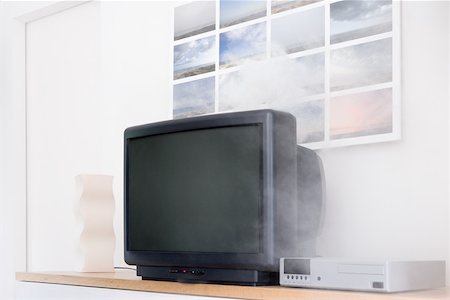 dangerous accident - Smoke coming out of a television Stock Photo - Premium Royalty-Free, Code: 614-01623501