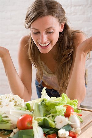 spanish ethnicity (female) - A woman looking at lots of vegetables Stock Photo - Premium Royalty-Free, Code: 614-01635378