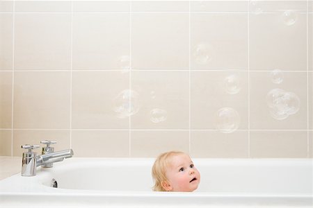 A baby boy looking at bubbles Stock Photo - Premium Royalty-Free, Code: 614-01699829