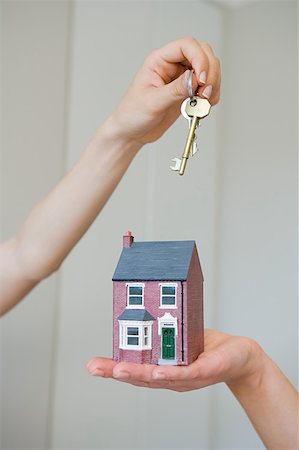 People holding keys and house Stock Photo - Premium Royalty-Free, Code: 614-01820443