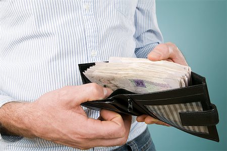 Man with banknotes in his wallet Stock Photo - Premium Royalty-Free, Code: 614-01870015