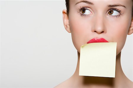 self adhesive note - Woman with adhesive note on her mouth Stock Photo - Premium Royalty-Free, Code: 614-02003540