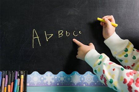 preschool - Girl writing on a blackboard Stock Photo - Premium Royalty-Free, Code: 614-02051003