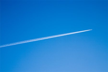 Airplane and vapour trail Stock Photo - Premium Royalty-Free, Code: 614-02073080