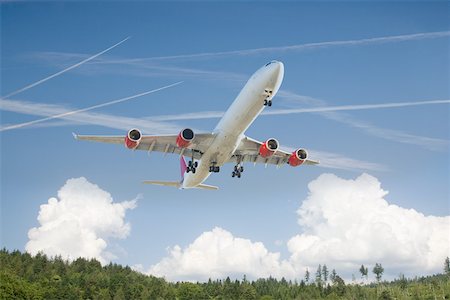 planes flying above the clouds - Airplane above a forest Stock Photo - Premium Royalty-Free, Code: 614-02073638