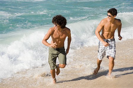 Teenage boys running on the beach Stock Photo - Premium Royalty-Free, Code: 614-02242571