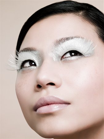 simsearch:649-07520416,k - A young woman wearing white false eyelashes Stock Photo - Premium Royalty-Free, Code: 614-02343530