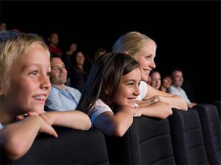 A mother and her children watching a movie Stock Photo - Premium Royalty-Free, Code: 614-02392989