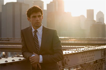 skyscrapers morning - Businessman leaning on a girder Stock Photo - Premium Royalty-Free, Code: 614-02393383