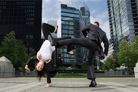 Businesspeople practising capoeira Stock Photo - Premium Royalty-Free, Code: 614-02393535