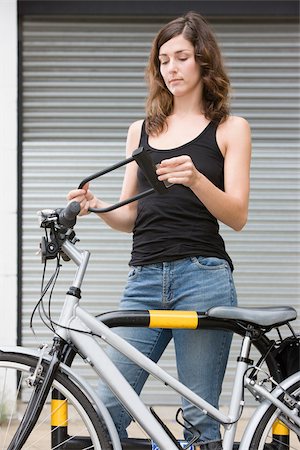 Woman with bicycle and lock Stock Photo - Premium Royalty-Free, Code: 614-02679473