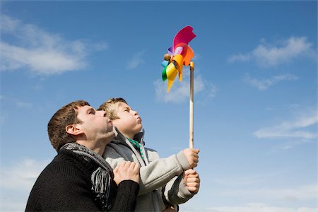 Father and son with pinwheel Stock Photo - Premium Royalty-Free, Code: 614-02680531