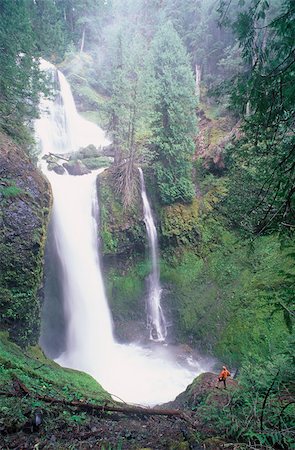 Hiker by waterfall at falls creek Stock Photo - Premium Royalty-Free, Code: 614-02739676