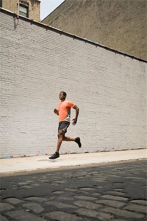 Runner on street Stock Photo - Premium Royalty-Free, Code: 614-02763075