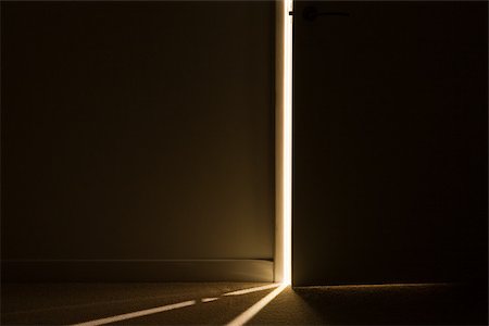 Light through the gap of an open door Stock Photo - Premium Royalty-Free, Code: 614-02763147