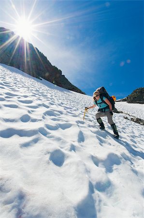 risk mountain - A female climber walking down a mountain Stock Photo - Premium Royalty-Free, Code: 614-02763245