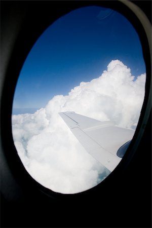 porthole - Looking out airplane window. Stock Photo - Premium Royalty-Free, Code: 614-02837591