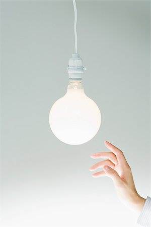 Hand and lightbulb Stock Photo - Premium Royalty-Free, Code: 614-02838781