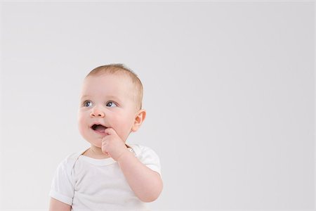 Baby with finger in mouth Stock Photo - Premium Royalty-Free, Code: 614-02985050