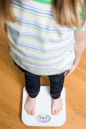 person on weigh scale - Girl standing on scales Stock Photo - Premium Royalty-Free, Code: 614-03020238