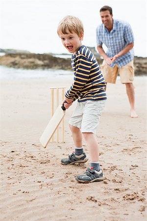 Father and son playing cricket on beach Stock Photo - Premium Royalty-Free, Code: 614-03080499