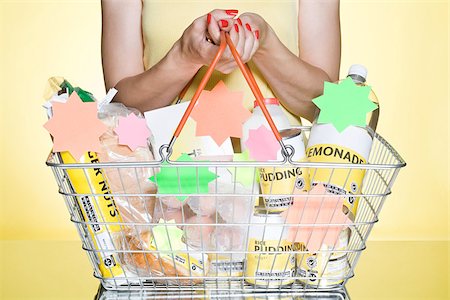 sticker - Woman with basic groceries in basket Stock Photo - Premium Royalty-Free, Code: 614-03191285