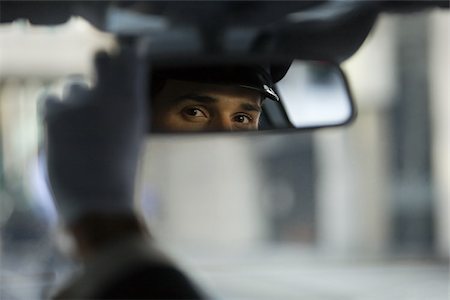 Chauffeur looking in the rear view mirror Stock Photo - Premium Royalty-Free, Code: 614-03191608