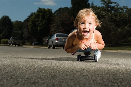 suburban - Little girl on a skateboard Stock Photo - Premium Royalty-Free, Code: 614-03228272