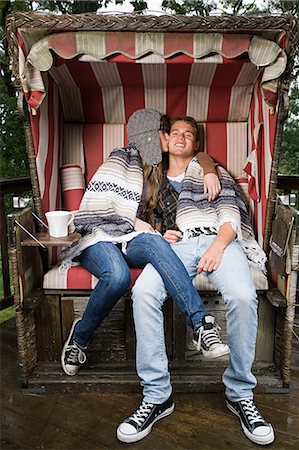 people sitting in chaise lounge - Young couple on beach chair Stock Photo - Premium Royalty-Free, Code: 614-03241329