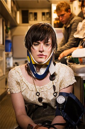 Injured young woman in an ambulance Stock Photo - Premium Royalty-Free, Code: 614-03241418