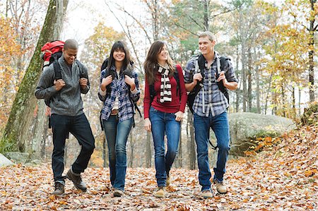 Young people hiking through forest Stock Photo - Premium Royalty-Free, Code: 614-03393324