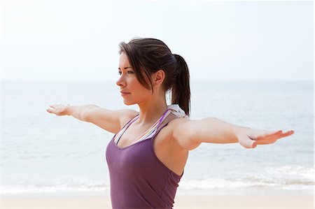 Woman practicing yoga by the sea Stock Photo - Premium Royalty-Free, Code: 614-03420390